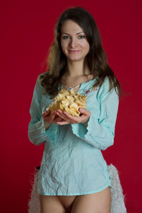 Solo girl Indy Z holds a conch shell while getting completely naked 83836691