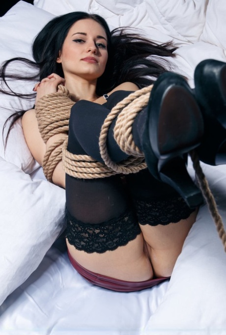 Dark haired teen Eva Kahil displays her shaved vagina while tied up with rope 53944374