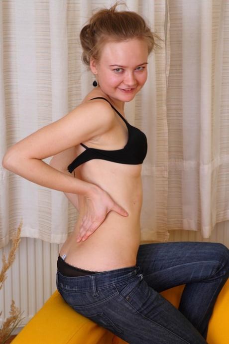 Charming young girl Vera gets naked in white socks on a sofa 21218087