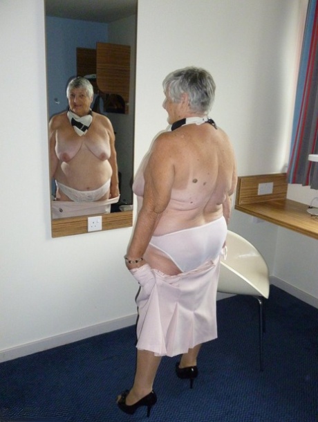 Obese old woman Grandma Libby lays her floppy tits on a desk while undressing 40661412