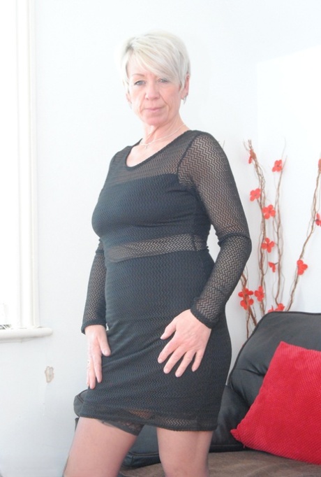 Sexy granny hikes up her dress to expose her shaved pussy in stockings 64706280