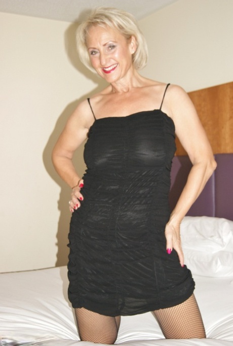 Middle-aged blonde Sugar Babe disrobes to nylons before masturbating 68257797
