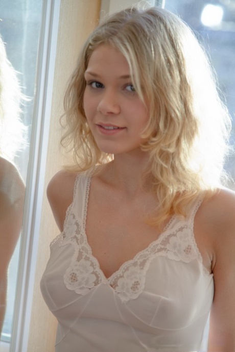 Sexy blonde teen Valya removes white lingerie in front of a window 44898343