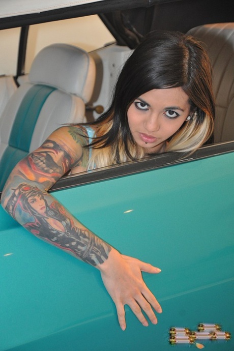 Tattooed brunette Holly D exposes her garters in lingerie and nylons 50949148