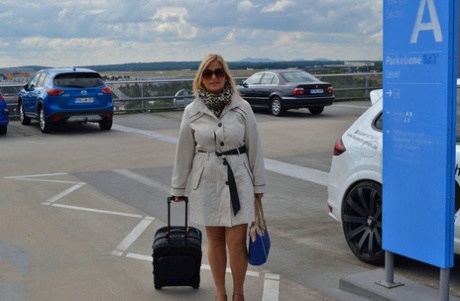 Mature blonde exposes herself in a trench coat at the airport 73174360