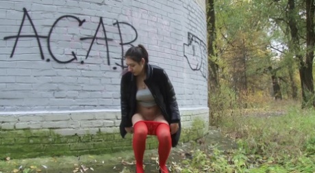 White girl Diana Sweet pulls down red pantyhose to pee behind a building 20136179