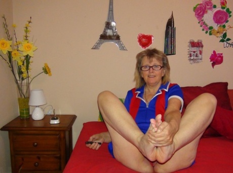 Barefoot older lady Abby Roberts sheds panties before masturbating on a bed 41913464
