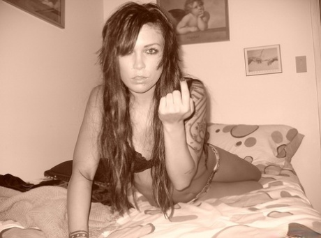Tattooed girl Deja teases on her bed in a bra and sheer panties 50441248