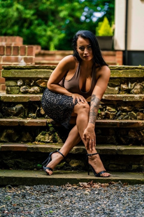 British model Kelli Smith holds her big tits well getting naked on patio steps 69574546
