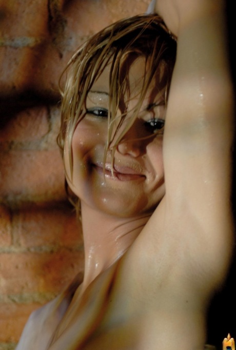 Glamour model gets soaking wet during a solo shoot afore a brick wall 34962399