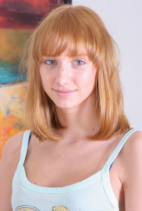 Barely legal redhead Rhea F gets totally naked on a leather sofa 82815676