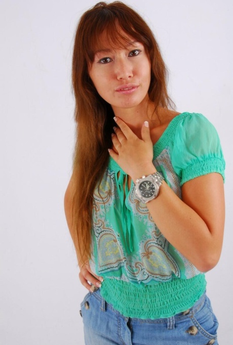 Asian redhead Evita models a large metal watch during a non-nude gig 68084879
