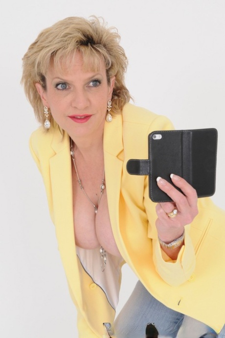 Older UK blonde Lady Sonia takes self shots of her enhanced boobs 53056941