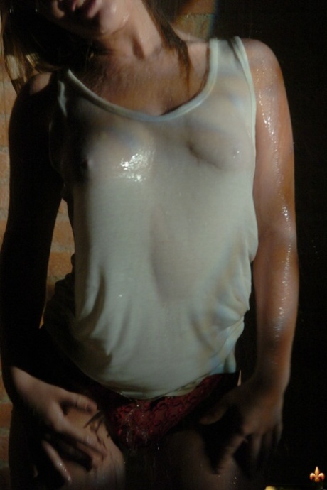 Blonde solo girl gets soaked in a tank top and red thong at night 63026954