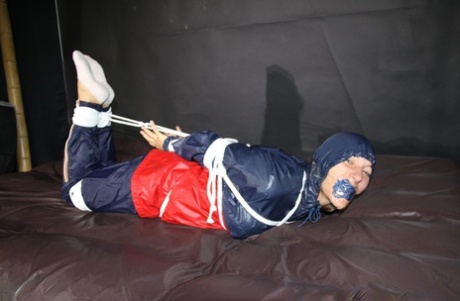 White girl Sandra is left bound up and gagged in nylon rainwear 76619706