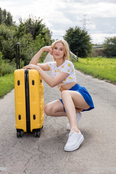 Blonde teen Lilly Mai gets naked over a suitcase on a rural road 88423094