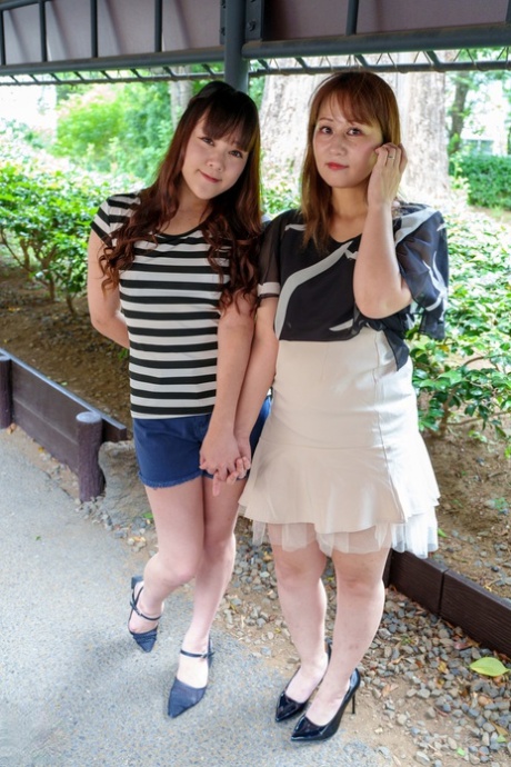 Japanese lesbians Kyoko Tachibana and Aki Sakura kiss before 69 sex on a sofa 21044575