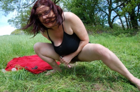 British amateur Juicey Janey dildos her bush on a red blanket in a field 49567129