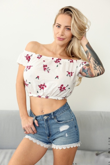 Tattooed blonde Nathaly Cherie puts her fake tits on display while going nude 70624637