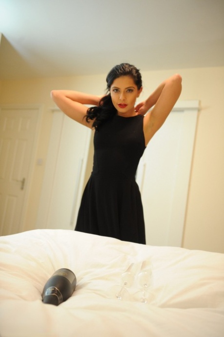 Dark haired beauty Cara De la Hoyde unzips her dress and gets naked 62888338