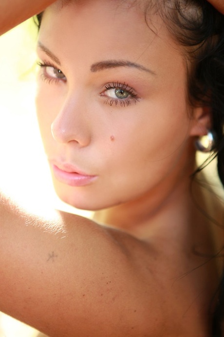 Dark haired teen Promise hits upon great nude poses up against a tree 39410485
