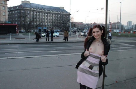 Playful redhead babe flashing her shapely titties in a public place 12247067